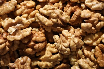 Pile of fresh ripe walnuts as background, top view