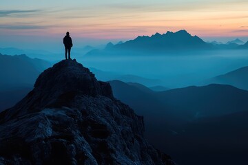 Silhouette of a solitary figure standing at the peak of a rugged mountain, looking out over a vast, twilight landscape