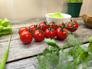 cherry tomatoes surrounded by greenery on the table. High-quality photo