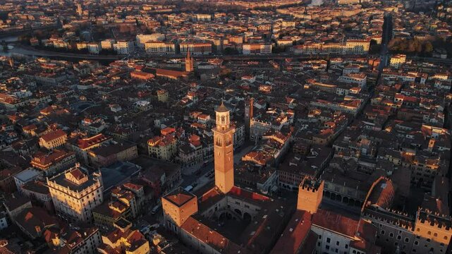 This top-down aerial shot rotates over Piazza delle Erbe at dawn, capturing the serenity of the square. The soft morning light gently illuminates the historic buildings, creating a peaceful scene.