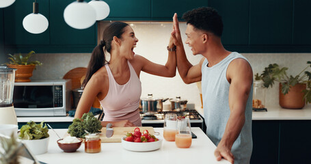 Kitchen, cooking and happy couple high five for success, fitness goal or food for nutrition. Woman, man and celebration in home together for achievement, healthy diet or excited for wellness target