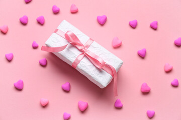 Gift box and hearts on pink background. Valentine's Day celebration