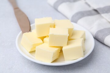 Pieces of fresh butter on white table, closeup