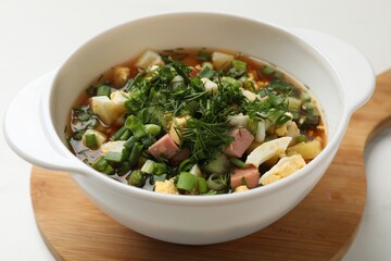 Delicious okroshka soup with kvass on white table, closeup