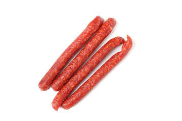 Many thin dry cured sausages isolated on white, top view