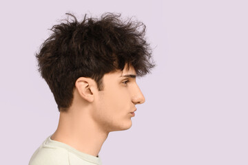 Fototapeta premium Young dark haired man on light background