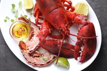Delicious boiled lobster served on grey table, top view