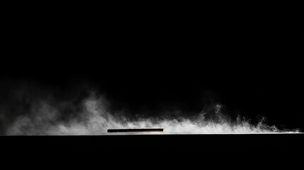 Fototapeta premium A serene image of smoke elegantly rising from a burning incense stick, set against a dark background, creating a minimalist and tranquil atmosphere.