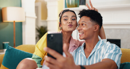 Couple, selfie and joke with peace sign, home and sofa for social media post. Man, woman and...