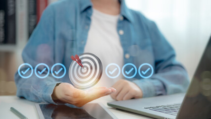 Businessman showing virtual target board on hand. Success concept, planning, and setting goals and objectives for business investment