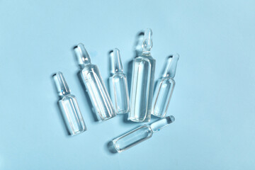 Medical ampules on blue background