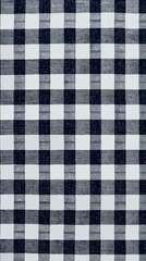Classic black and white plaid pattern fabric used for various textile projects and home decor