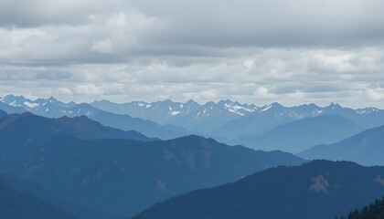Majestic Panoramic View of a Mountain Range Under a Cloudy Sky, Showing Layers of Peaks and Valleys