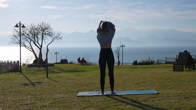 Girl undresses before training in the park