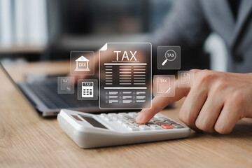 Corporate and individual tax payment concept, businessman using computer filling out corporate and personal income tax return, VAT and property tax of business.
