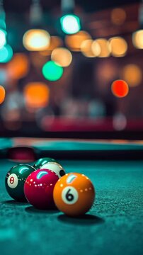 Colorful billiard balls arranged on a pool table in a vibrant setting with blurred lights in the background