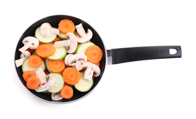 Frying pan with fresh vegetables and mushrooms isolated on white, top view
