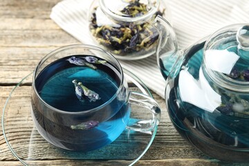 Delicious butterfly pea flower tea on wooden table, closeup