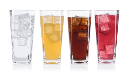 Soda water of different flavors with ice cubes in glasses isolated on white