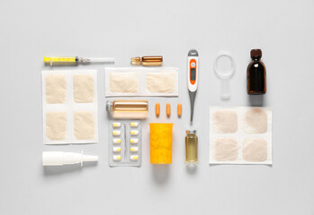 Mustard plasters with medical supplies on light background