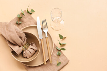 Beautiful table setting with eucalyptus on beige background