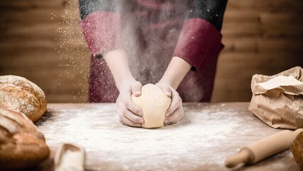Baking bread dough kneading rustic kitchen food preparation cozy atmosphere close-up view culinary artistry