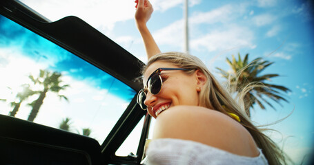 Woman, freedom and sunglasses in car of road trip adventure, travel break and blue sky. Happy, female person and convertible vehicle of scenery drive, transport journey and summer vacation in Florida