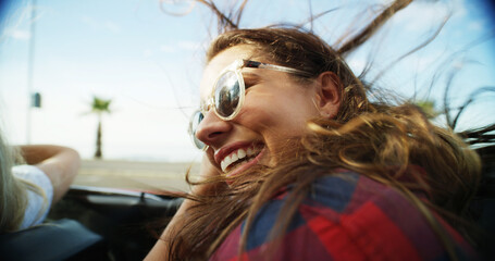 Woman, laughing and sunglasses in convertible for road trip adventure, travel break and breeze outdoor. Happy, female person and sports car with scenery drive, transport journey and summer vacation