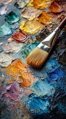 Fototapeta premium Close-up of an oil palette with various colors and brushes, showing the artist's tools and the texture of the oil paint.