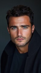 Fototapeta premium A detailed headshot of a man with piercing eyes and short, clean-shaven facial features, dressed in a dark jacket.
