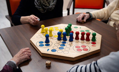 Four woman in a nursing home playing a board game