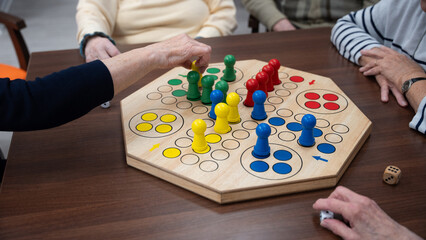 Four woman in a nursing home playing a board game