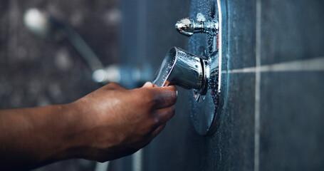 Hand, shower and faucet for hygiene, skincare and cleaning with routine in bathroom. Person, liquid...