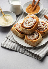 Freshly baked cinnamon rolls topped with icing and almond slivers