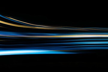 Abstract light trails in motion on a black background