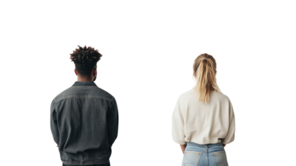 Young couple standing together from behind in neutral setting with contrasting outfits