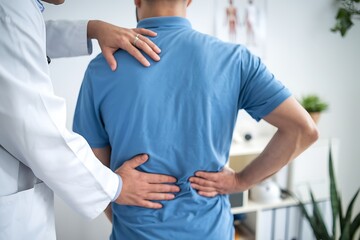 Doctor Examining Patient’s Lower Back Pain
