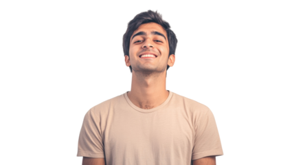 Young man smiling warmly against a plain background, exuding happiness and positivity in a casual setting