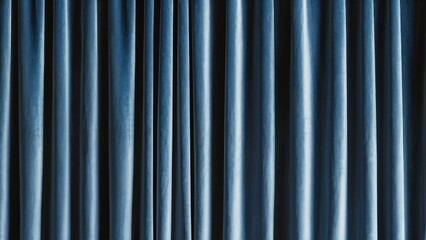 Obraz premium Opulent blue velvet curtains create a sophisticated abstract backdrop with rich textures and deep shadows in a calming vertical arrangement.