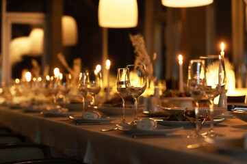 Elegant evening dining with candlelight and fine table settings in a modern restaurant