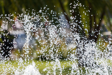A large spray of water is coming out of a fountain
