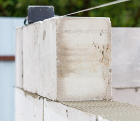 A white brick wall with a wire running through it