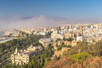 Fototapeta premium Malaga, seaside city in Andalusia, Spain, Europe. Panoramic city view with harbor, mountains, and lush greenery. A blend of modern and historical architecture.