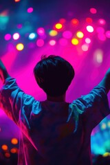 Crowd at a music concert with colorful lights illuminating the scene. Energetic audience celebrating and enjoying live performance in vibrant atmosphere.