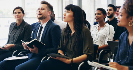 Notes, group and business people at seminar with attention for corporate training, development or...