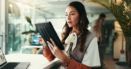 Woman, tablet and review plan in office, digital article and online for creative journalism. Mature female person, professional column and news website for editing spelling, publishing and working