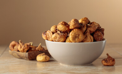 Organic dried figs on a beige background.