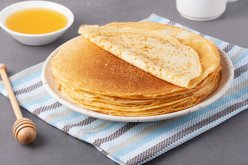 Stack of traditional russian pancakes blini on a white table. Homemade russian thin pancakes blini. Russian food, russian kitchen