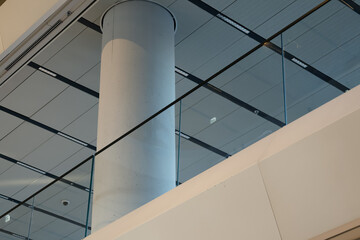 modern interior with glass railing and concrete column