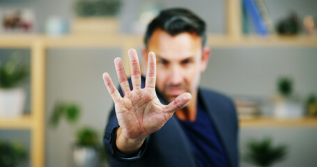 Portrait, business and man with stop hand, warning and fraud prevention in modern office. Face,...